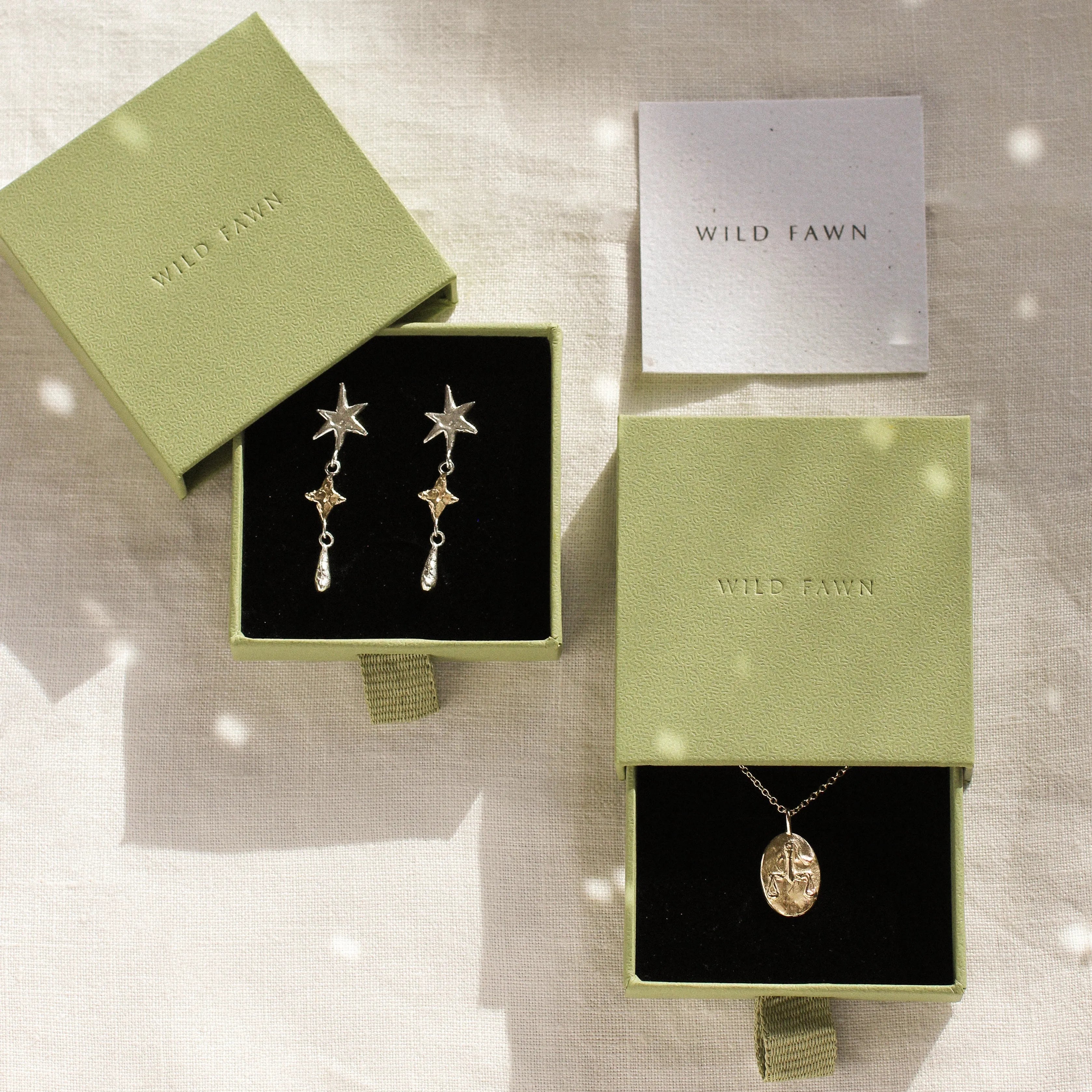 gold libra necklace and shooting star dangle earrings in green gift boxes and wild fawn care card