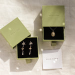 gold virgo necklace and star earrings in green wild fawn boxes