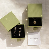 gold virgo necklace and star earrings in green wild fawn boxes
