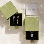 silver libra necklace and shooting star earrings in green gift boxes with wild fawn care card