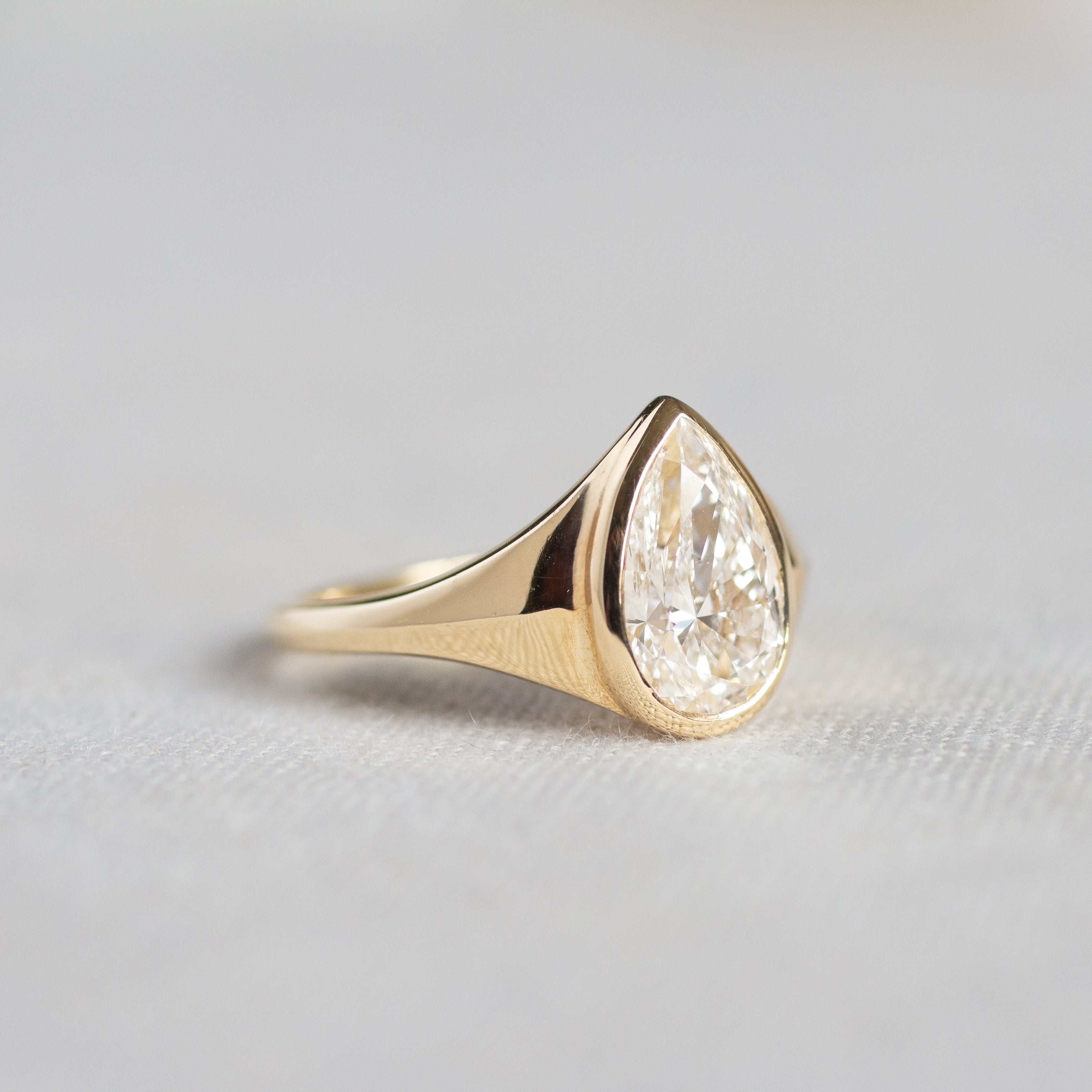 Statement Bezel Set Pear Diamond Engagement Ring