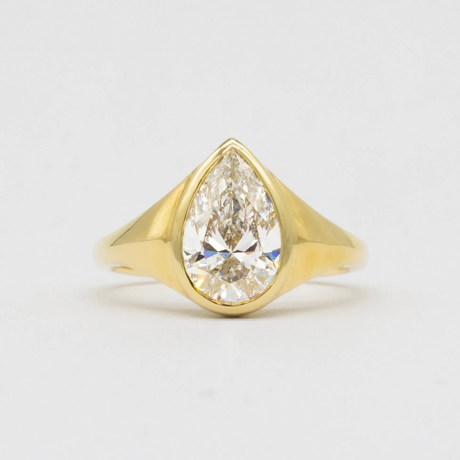 Statement Bezel Set Pear Diamond Engagement Ring