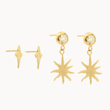 Gold earrings with four-point star and diamond sun dangle designs on a white background