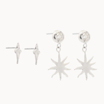 white gold star-shaped studs and diamond and sun dangle earrings on a white background