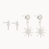 white gold star-shaped studs and diamond and sun dangle earrings on a white background