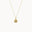 gold necklace with sunshine motif on a white background