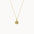 gold necklace with sunshine motif on a white background