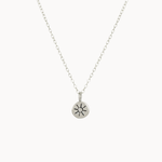 Silver necklace with a sun pendant on a white background