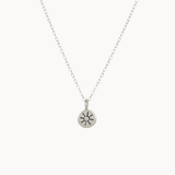 Silver necklace with a sun pendant on a white background