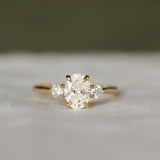 Gold ring with a three diamonds on a soft gray background