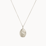 Silver taurus necklace with a textured pendant on a white background