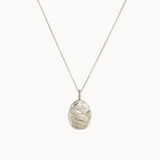 Silver taurus necklace with a textured pendant on a white background