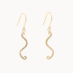 A pair of gold wavy dangle earrings with textured finishes and fishhook backings, shown against a plain off-white background.