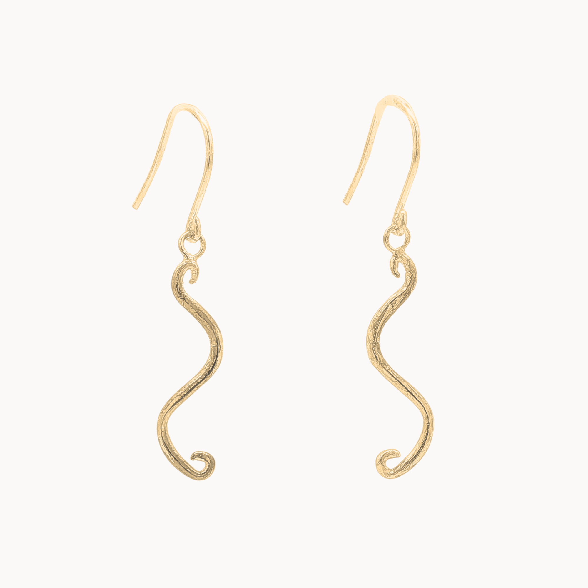 A pair of gold wavy dangle earrings with textured finishes and fishhook backings, shown against a plain off-white background.