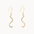 A pair of gold wavy dangle earrings with textured finishes and fishhook backings, shown against a plain off-white background.