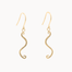 A pair of gold wavy dangle earrings with textured finishes and fishhook backings, shown against a plain off-white background.