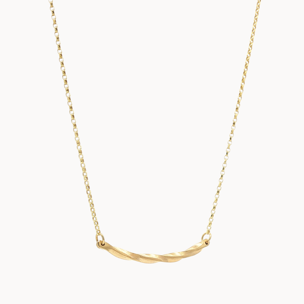 gold necklace with wavy curve pendant on white background
