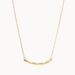 gold necklace with wavy curve pendant on white background