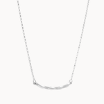 Silver necklace with a curved pendant on a white background