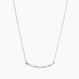 Silver necklace with a curved pendant on a white background