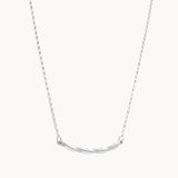 Silver necklace with a curved pendant on a white background