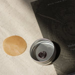 wax with fingerprint impring in a silver tin in the sun