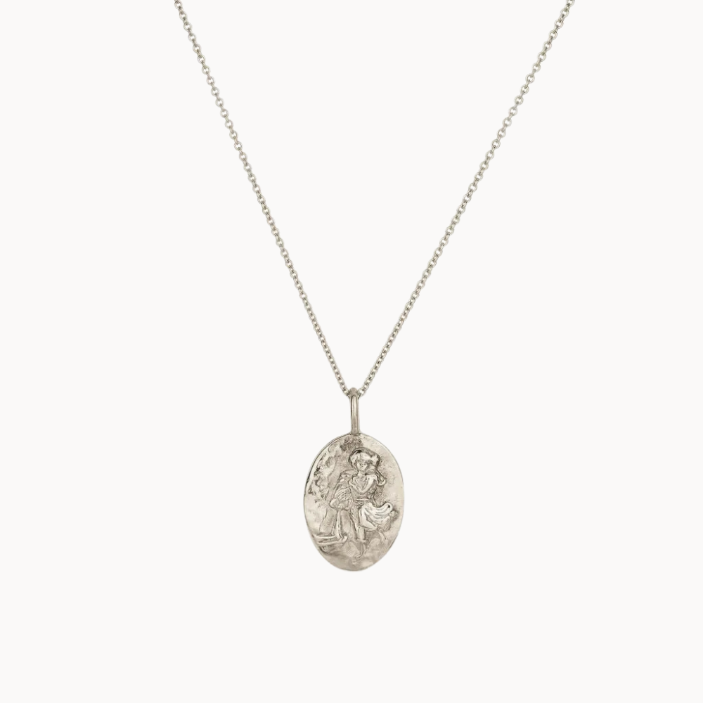 silver aquarius necklace with engraved design on a white background