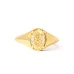 A yellow gold signet engagement ring featuring a large oval brilliant-cut yellow diamond center stone, set against a plain white background.