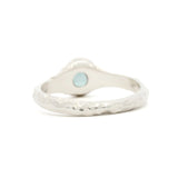 back view of Solitaire Blue Sapphire Molten Organic Engagement Ring on a white surface