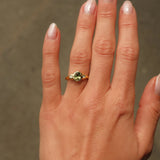 hand wearing a Oval Green Sapphire and Diamond Molten Organic Engagement Ring