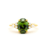 Large Green Sapphire Engagement Ring with Pear & Round Diamond Cluster on a white background