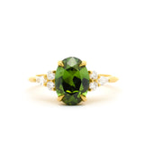 Large Green Sapphire Engagement Ring with Pear & Round Diamond Cluster on a white background