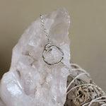 silver circle bracelet on crystal with sage in background