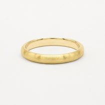 Gold 3mm brushed wedding ring on a white background