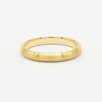 Gold 3mm brushed wedding ring on a white background