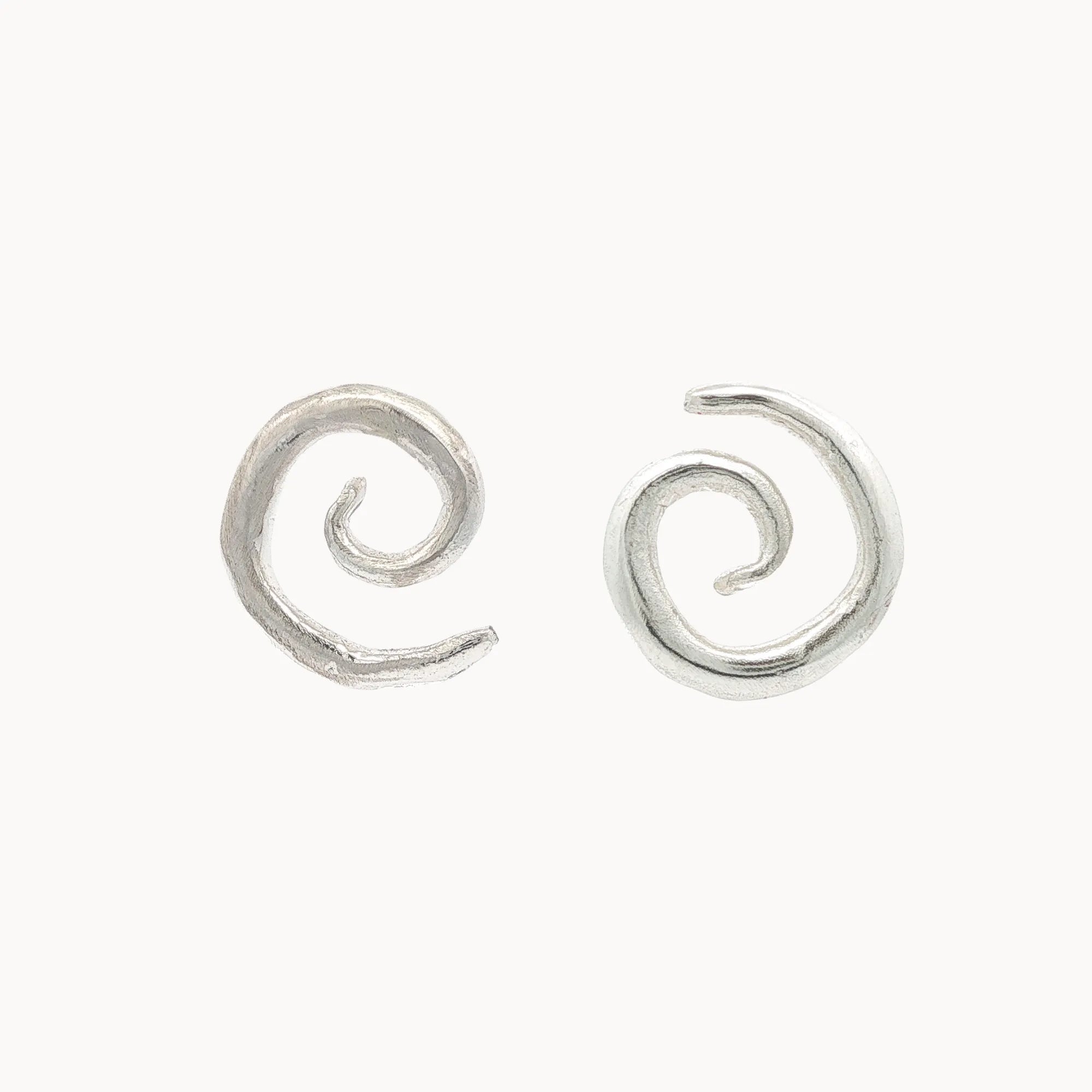 Silver spiral earrings on a white background