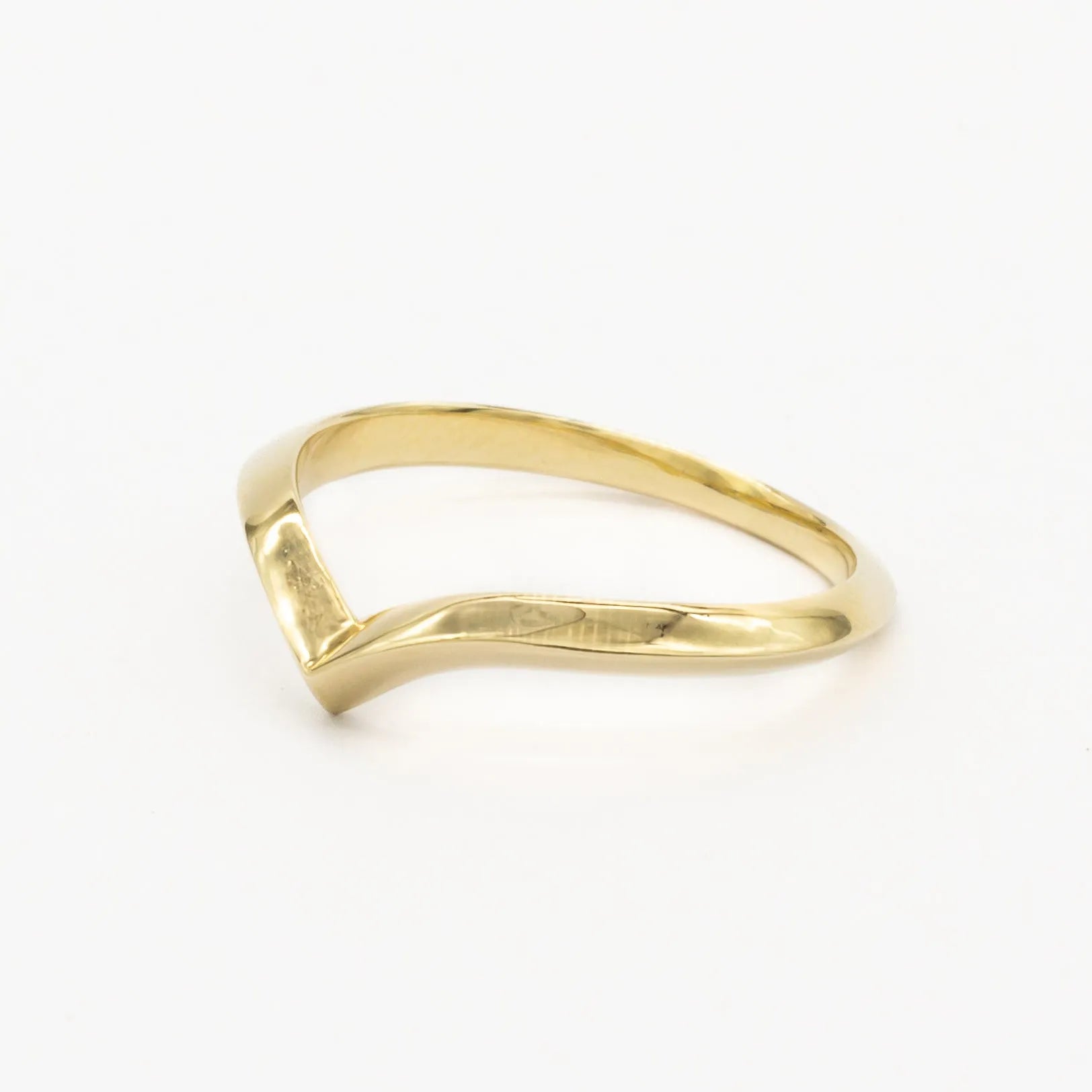 side angle of 2mm chevron wedding ring in gold on white background