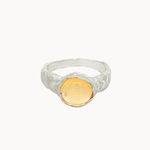 silver textured ring with round orange citrine gemstone on a white background