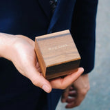close up of closed wooden ring box with wild fawn embossed in gold metallic font