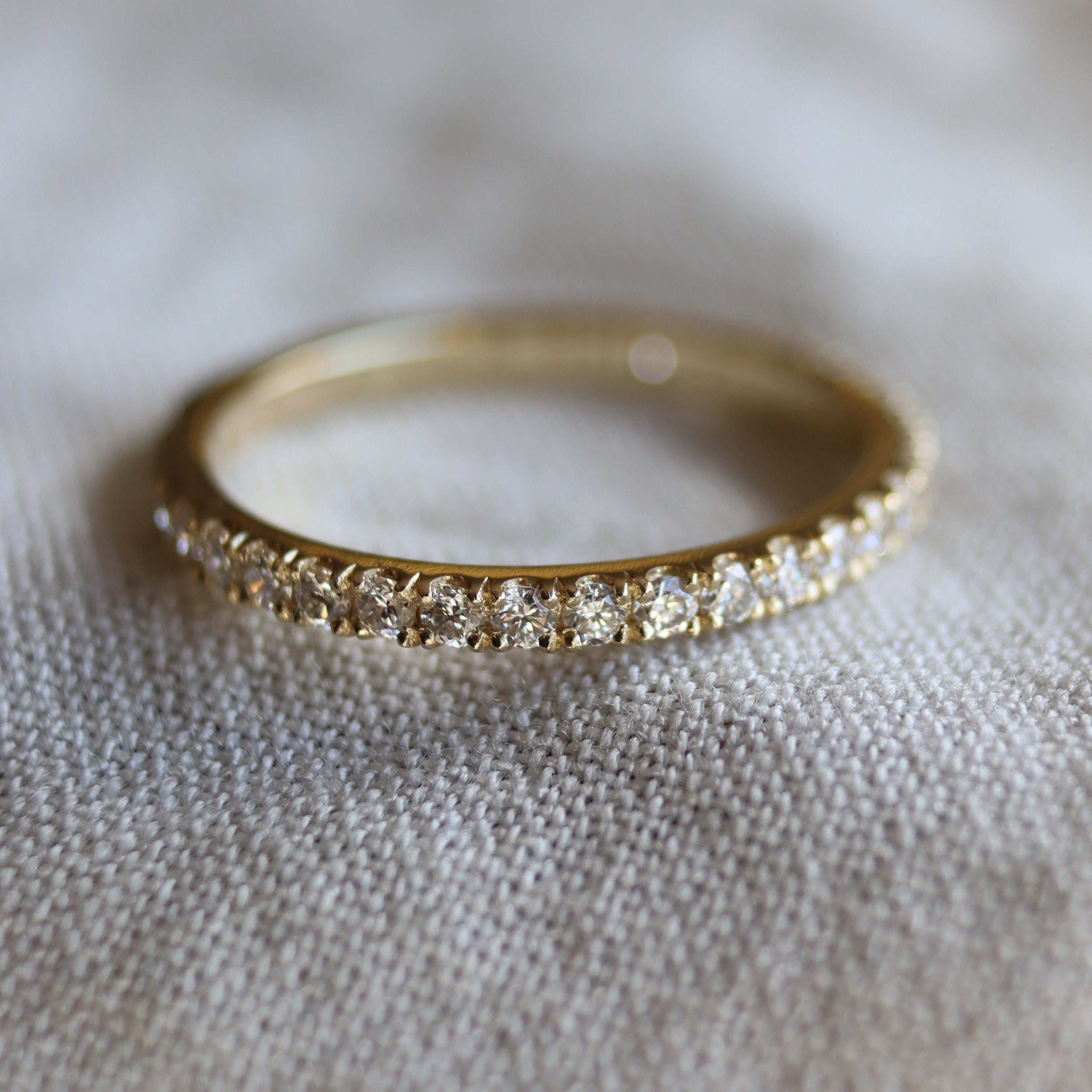 bespoke wedding ring with small diamonds around the band