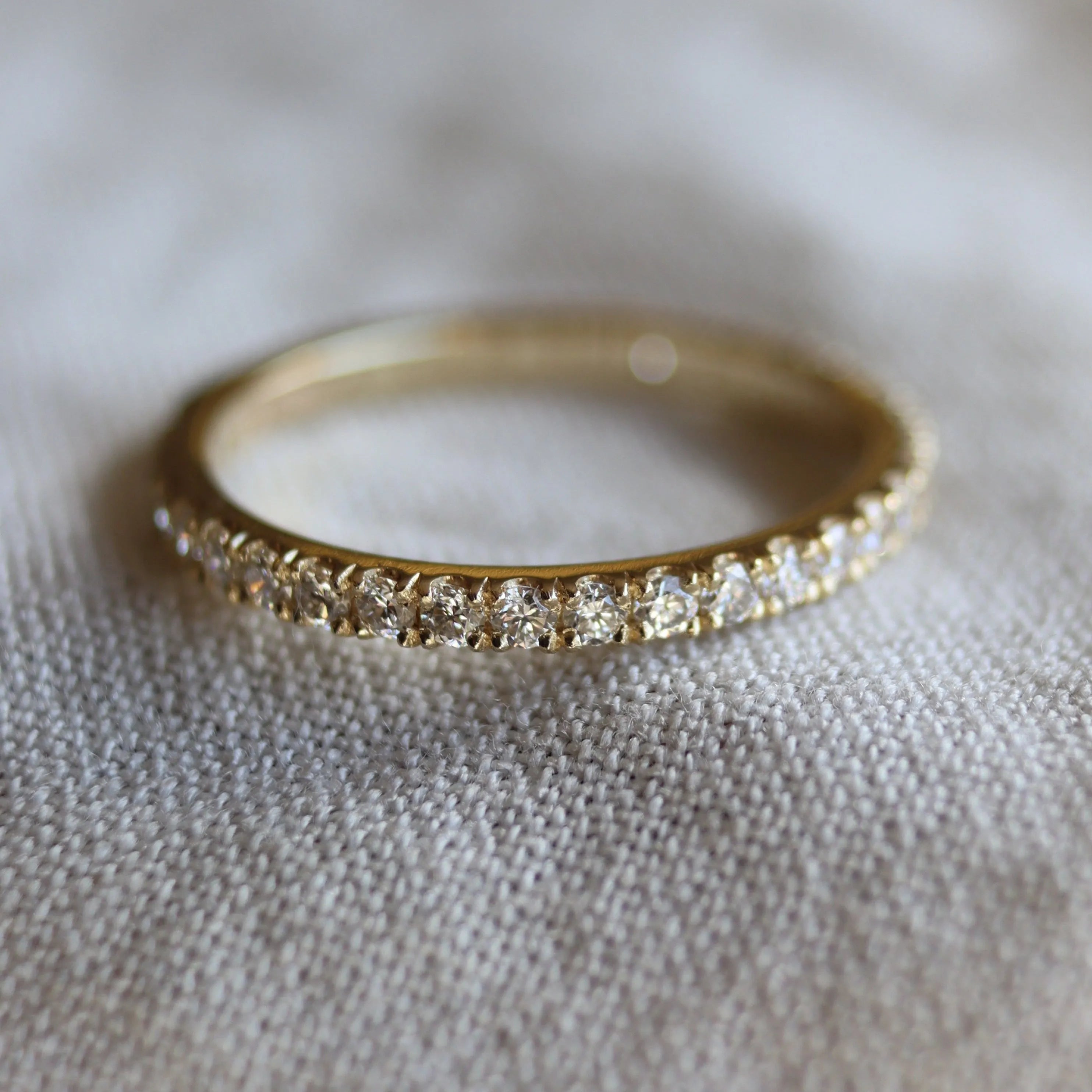 bespoke wedding ring with small diamonds around the band
