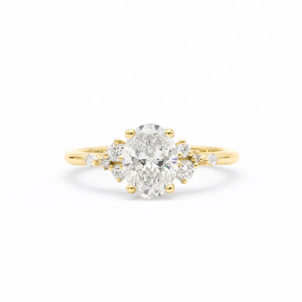 A yellow gold ring featuring a large oval-cut center diamond surrounded by smaller round diamonds on the shoulders, set against a clean white background.