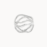 A silver-toned multi-band ring with organic, wavy, flowing lines, presented on a clean off-white background.