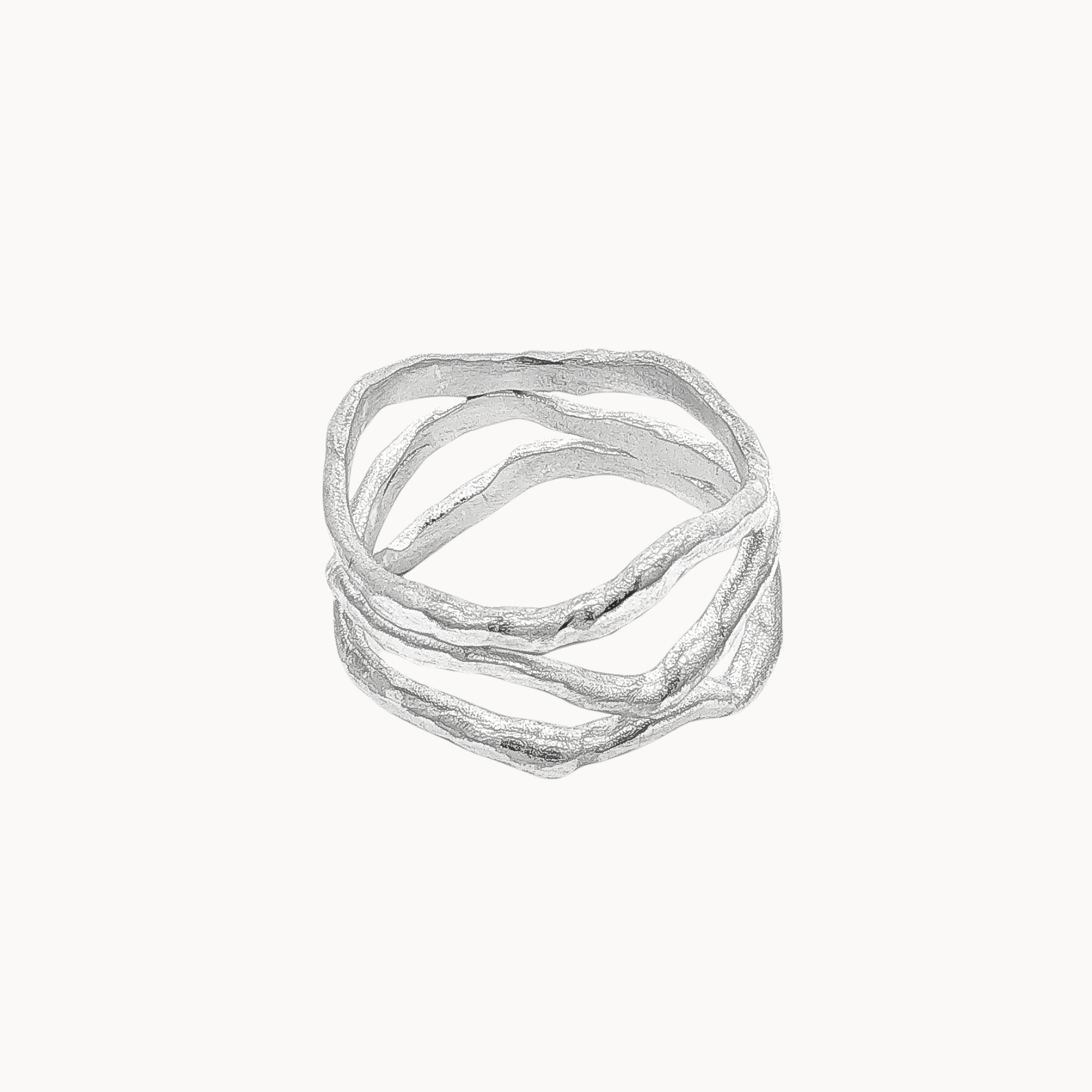 A textured silver ring with multiple organic, wavy bands overlapping in a stacked design, shown against a plain off-white background.