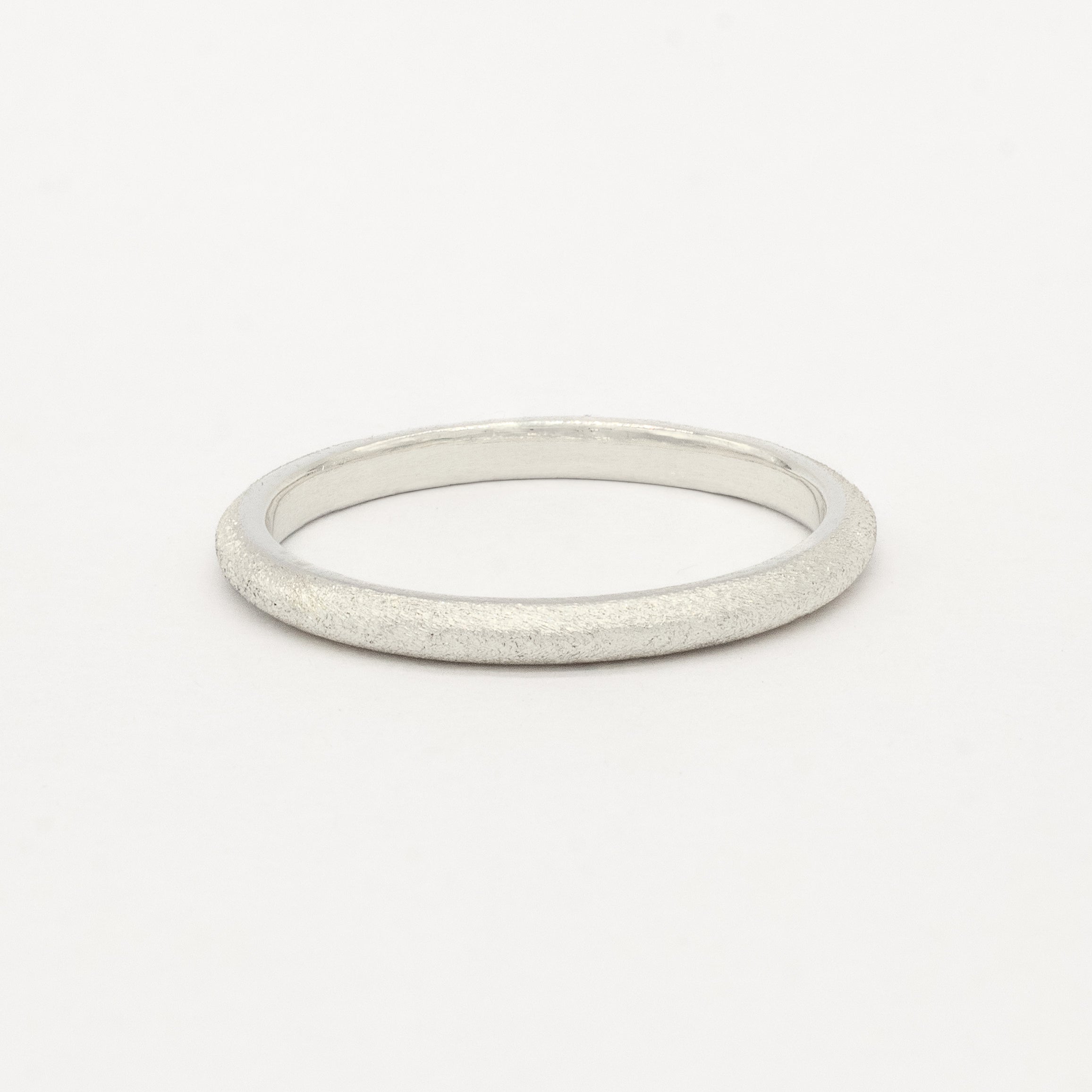 2mm wide slmi white gold frosted ring on a light gray background