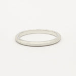 2mm wide slmi white gold frosted ring on a light gray background