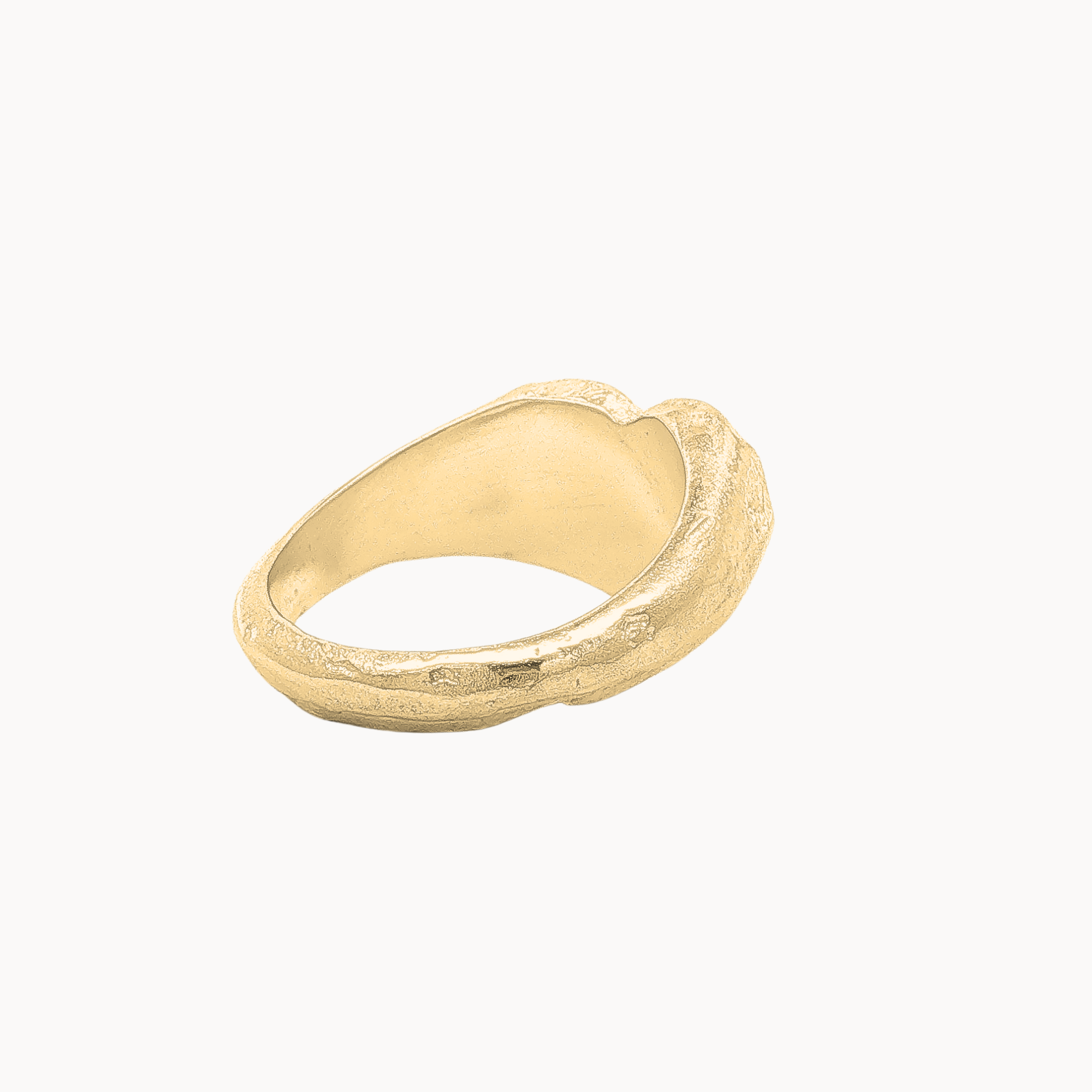 back view of a organic heart signet ring in gold against a plain off-white background