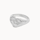 A textured sterling silver heart signet ring with a sculpted, organic texture, shown on a plain off-white background.