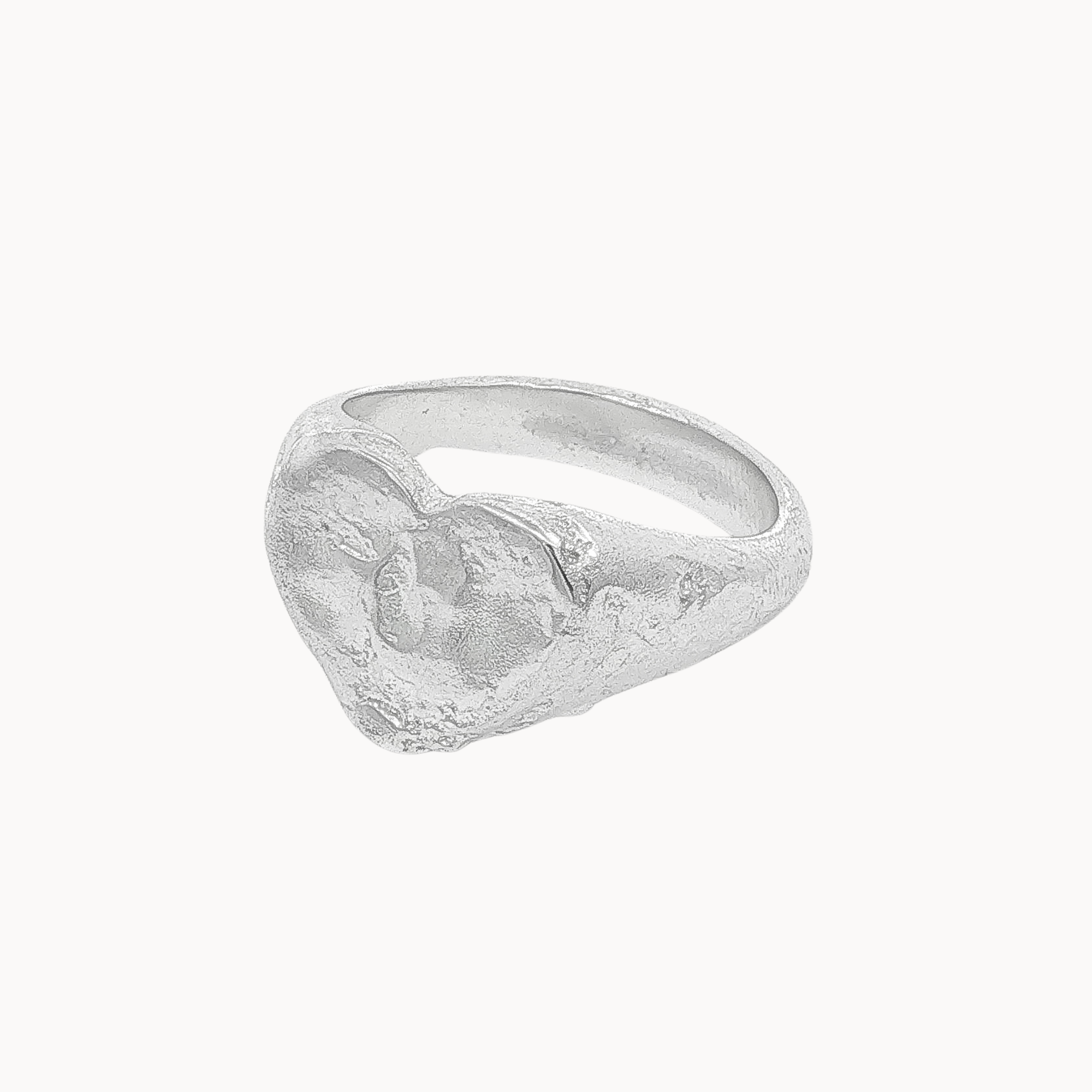 A textured sterling silver heart signet ring with a sculpted, organic texture, shown on a plain off-white background.