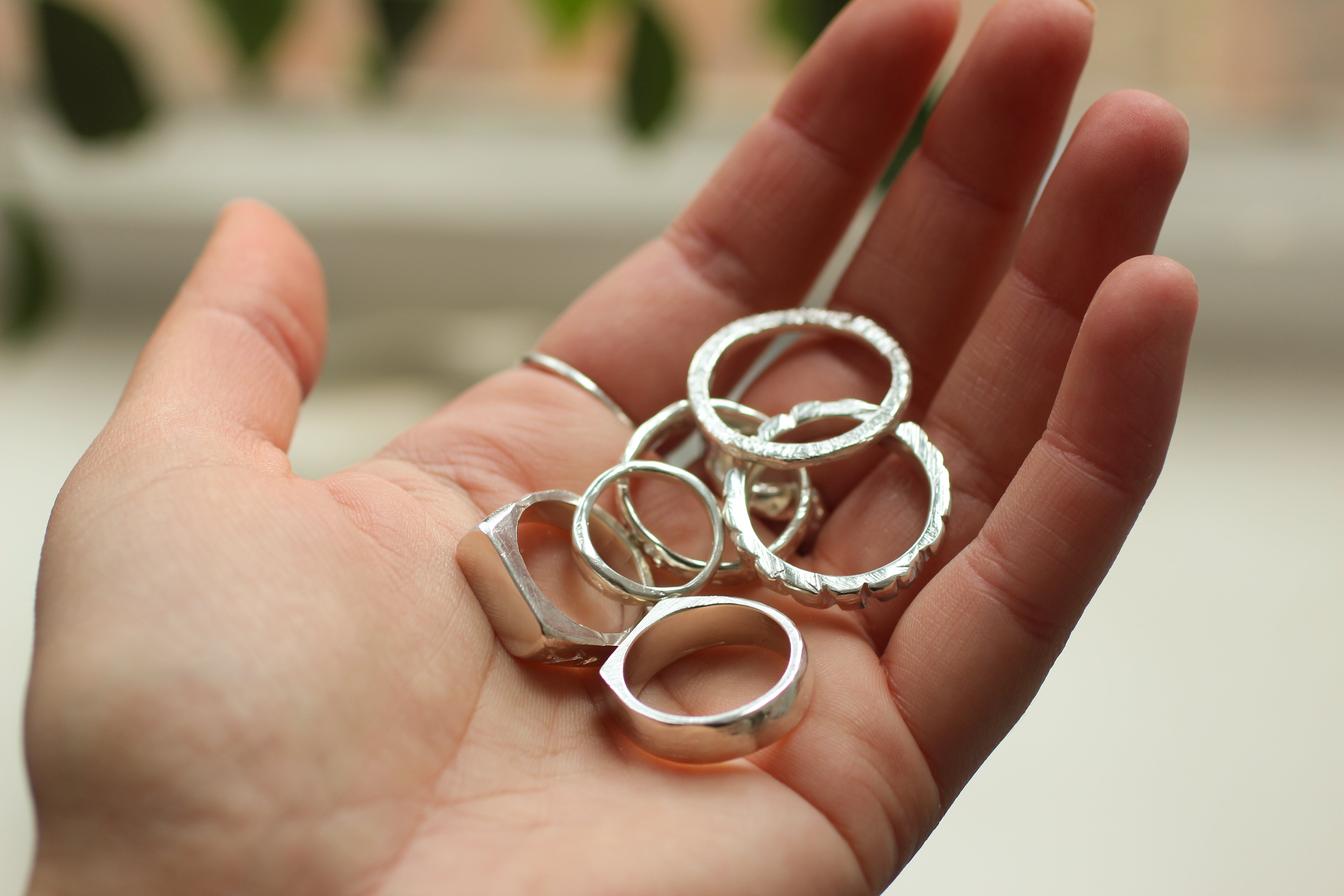 hand holding silver handmade rings